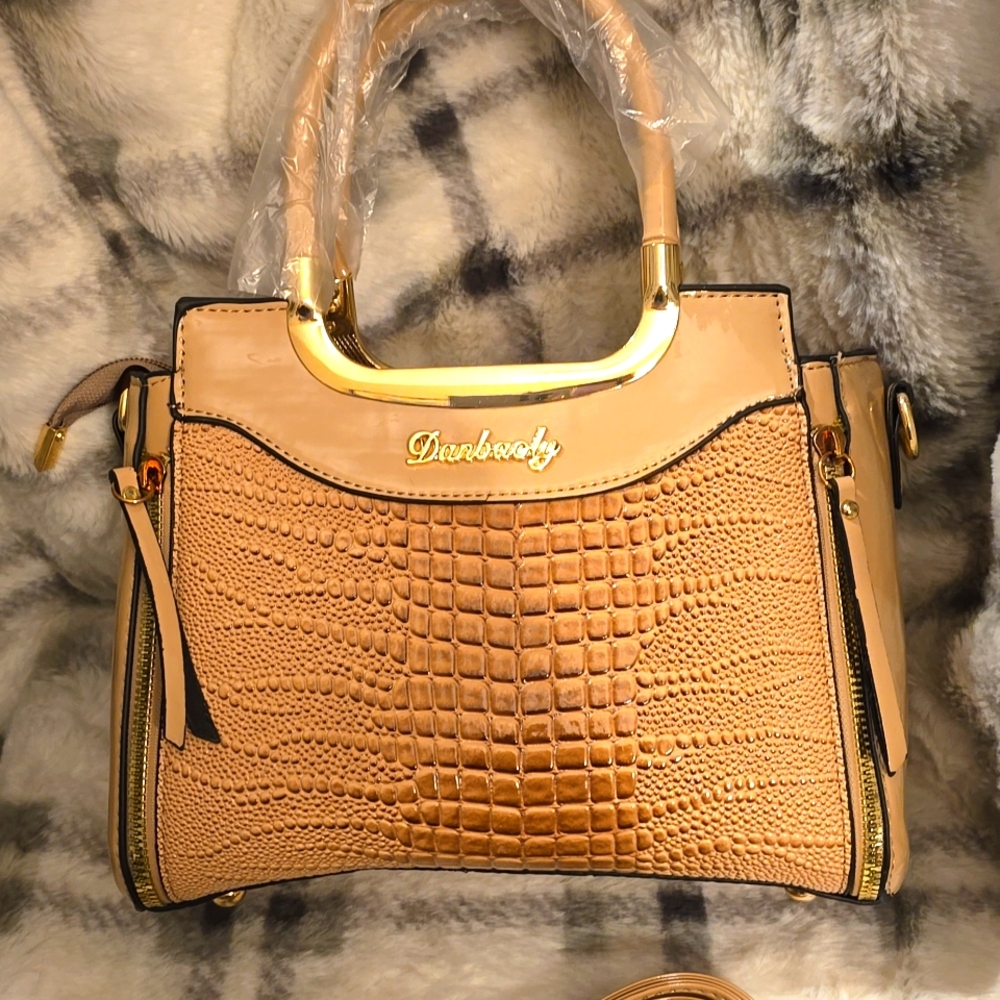 Sophisticated looking bag with faux paten leather. Versatile for day / night